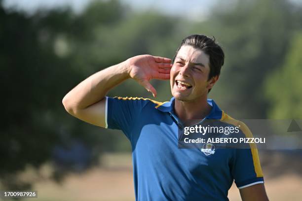 Europe's Norwegian golfer, Viktor Hovland reacts on the 15th green after his win over US golfer, Collin Morikawa in their singles match on the final...