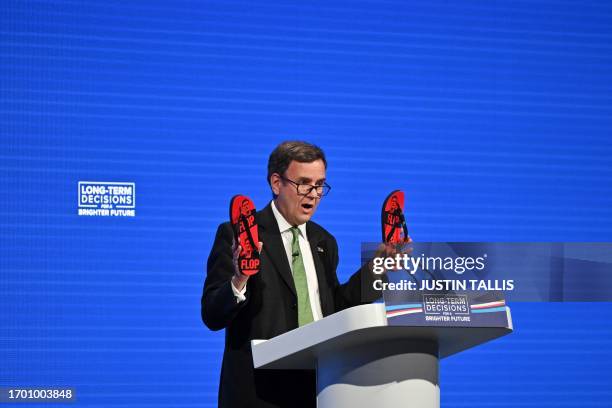 Chairman of the British Conservative Party and MP Greg Hands shows flip flops depicting leader of the British Labour party Keir Starmer as he...