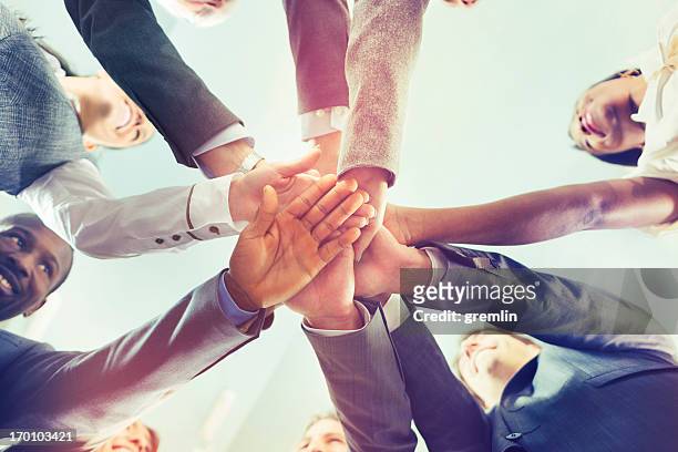 unity of successful multi-ethnic business people holding hands - honesty stock pictures, royalty-free photos & images