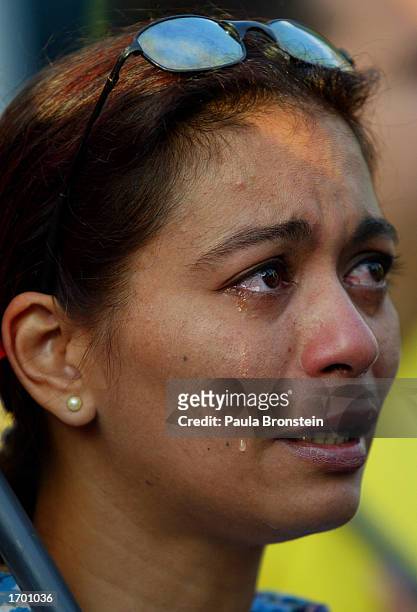 Venezuelan woman cries during an emotional outdoor Christmas Eve service organized by the opposition supporters December 24,2002 in Caracas,...