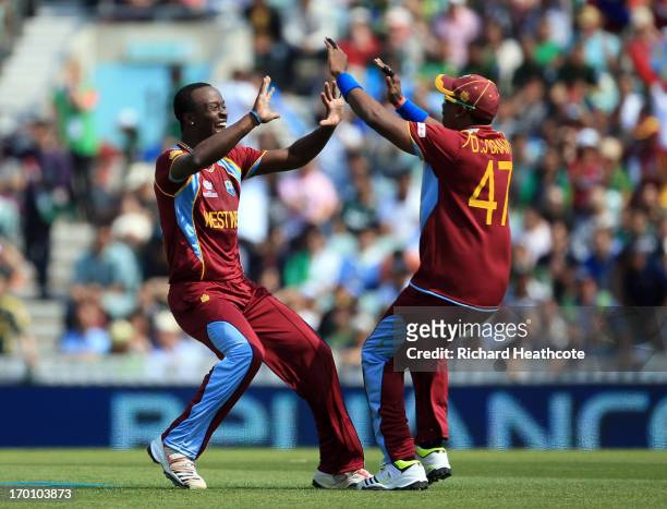 Kemar Roach of the West Indies celebrates taking the wicket of Asad Shafiq of Pakistan during the ICC Champions Trophy group B match between West...