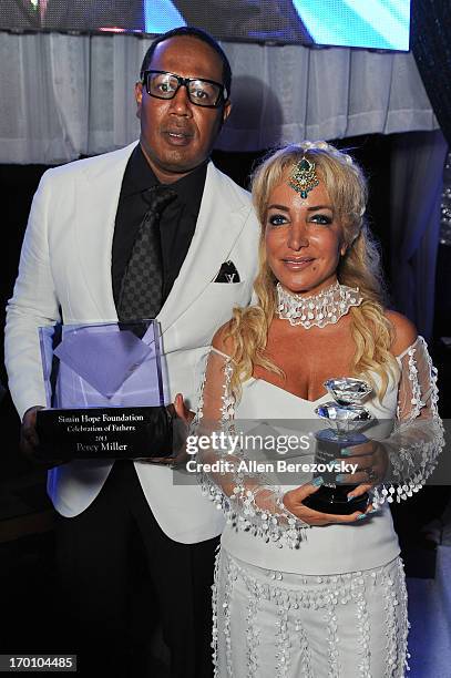 Rapper/producer Percy Miller and Simin Hashemizadeh pose withe their awards during a Celebration of All Fathers' Gala Dinner with Andrea Bocelli at...