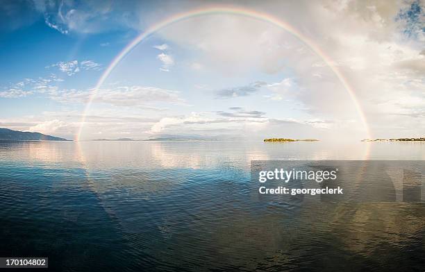 full rainbow over the sea - rainbow light reflection stock pictures, royalty-free photos & images