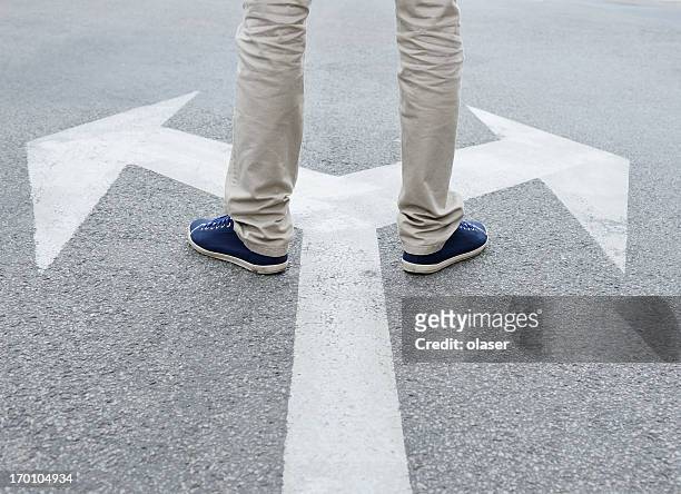 man standing hesitating to make decision - footpath stock pictures, royalty-free photos & images