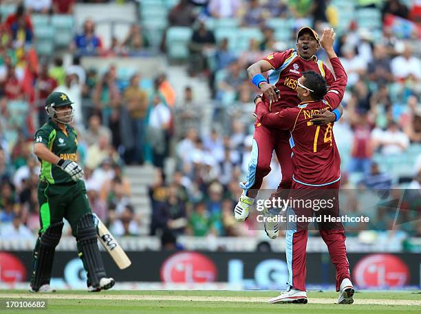 Sunil Narine of West Indies is congratulated by Dwyane Bravo as he takes with wicket of Kamran Akmal of Pakistan during the ICC Champions Trophy...