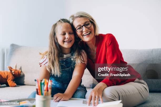 happy grandmother and granddaughter spending quality time drawing together at home - school closing stock pictures, royalty-free photos & images