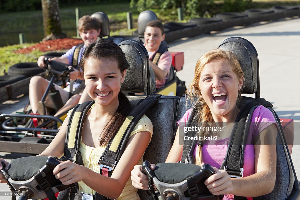 Teenagers riding go-carts