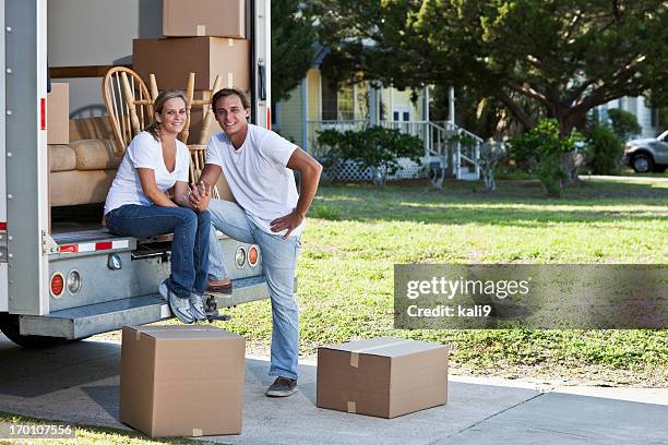 young couple with moving truck - removal van stock pictures, royalty-free photos & images