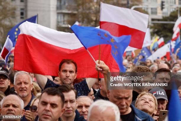 Demonstrator holds up the Polish flag during a rally, called by the opposition, in Warsaw on October 1, 2023. Polish opposition leader Donald Tusk...