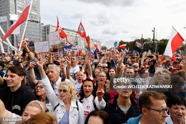 Demonstrators react as Polish opposition leader, former premier and head of the centrist Civic Coalition bloc, Donald Tusk addresses participants of...