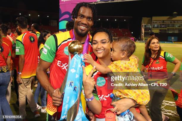 Keemo Paul, of Guyana Amazon Warriors, along with his family pose for a photo with the Republic Bank Caribbean Premier League Trophy after winning...