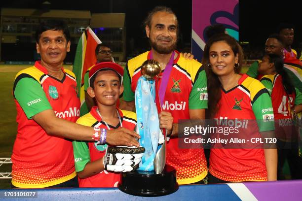 Imran Tahir, of Guyana Amazon Warriors, along with his family and friend pose for a photo with the Republic Bank Caribbean Premier League Trophy...