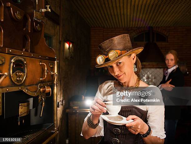 young woman and man in steampunk stile make a coffee - steampunk stock pictures, royalty-free photos & images