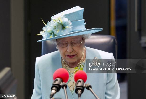 Britain's Queen Elizabeth II reads a statment in a live broadcast from Radio 4 studios during her visit to the BBC as she officially opened the...