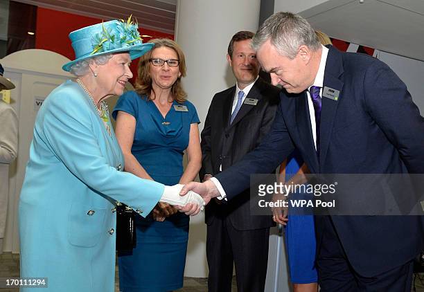 Queen Elizabeth II meets newsreader Huw Edwards as she opens the new BBC Broadcasting House on June 7, 2013 in London, England.