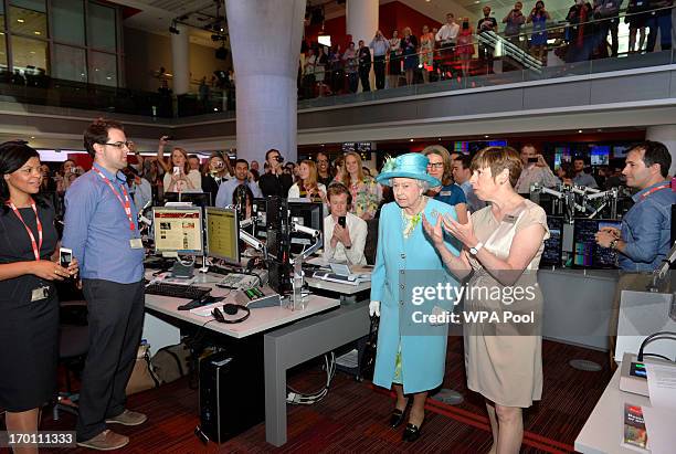 Queen Elizabeth II is given a tour of the newsroom as she opens the new BBC Broadcasting House on June 7, 2013 in London, England.