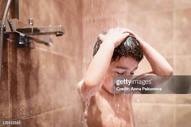 boy taking a shower - boy taking a shower stock-fotos und bilder