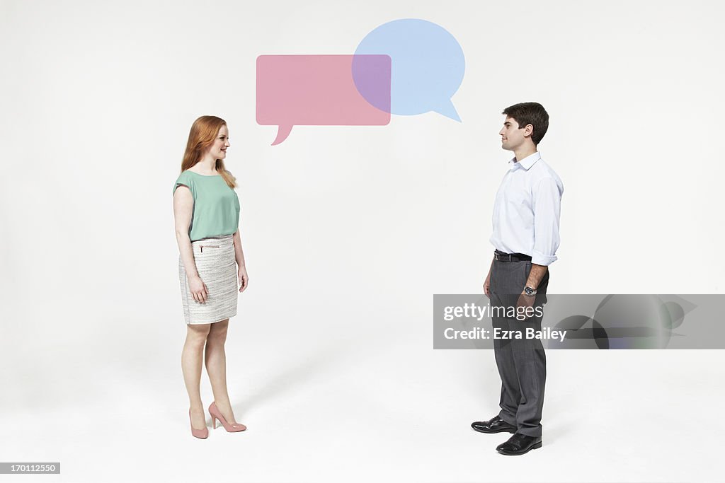 Man and woman with perspex speech bubbles.