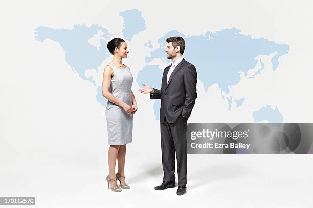 business people chatting in front of world map. - mens dress shoes stock pictures, royalty-free photos & images