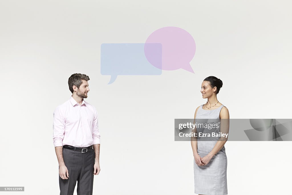 Man and woman with perspex speech bubbles.