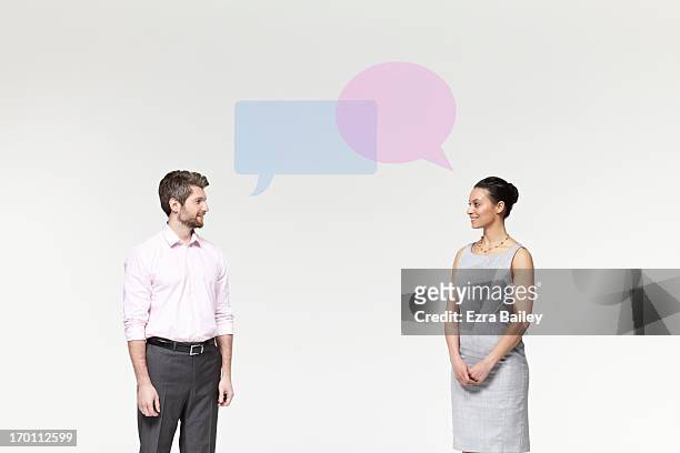 man and woman with perspex speech bubbles. - faccia a faccia foto e immagini stock