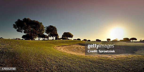 golf bunker against setting sun - golf bunker low angle stock pictures, royalty-free photos & images