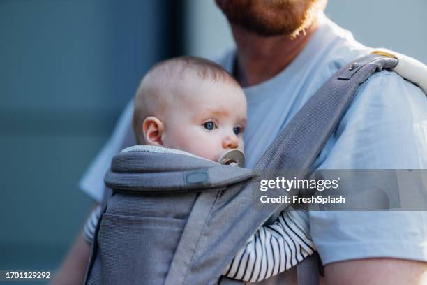 daddy's little explorer: father and baby in the city - baby carrier stock pictures, royalty-free photos & images