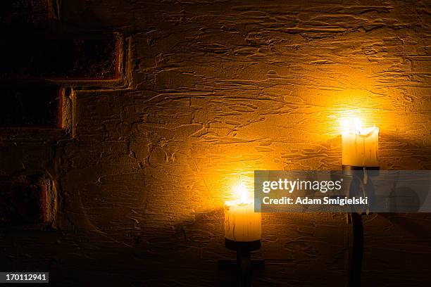 brick wall with candles - candle holder stock pictures, royalty-free photos & images