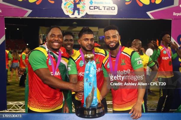 Odean Smith, Chandrapaul Hemraj and Shai Hope of Guyana Amazon Warriors, pose for a photo with the Republic Bank Caribbean Premier League Trophy...