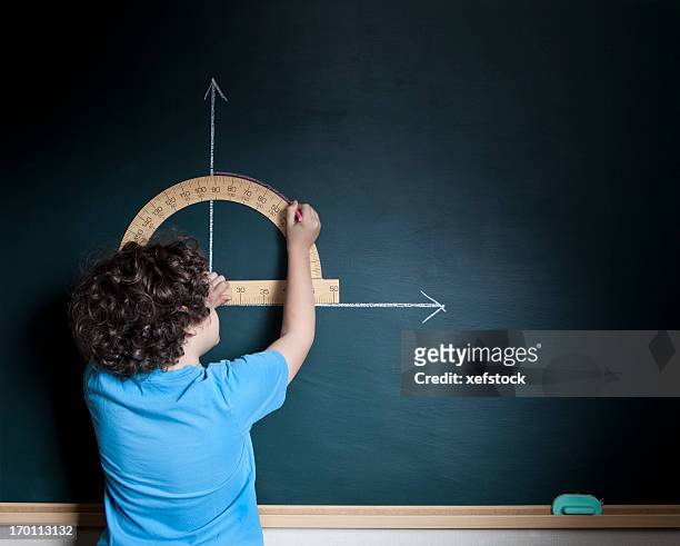 child calculating on blackboard - protractor stock pictures, royalty-free photos & images