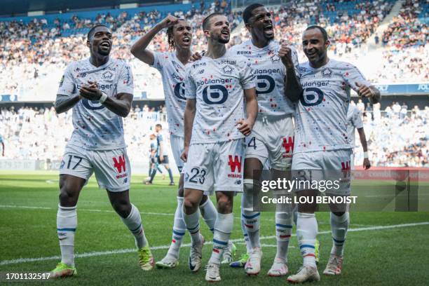 Lille's players celebrate the own goal by Le Havre's French defender Yoann Salmier during the French L1 football match between Le Havre AC and Lille...