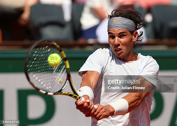 Rafael Nadal of Spain plays a backhand during the men's singles semi-final match against Novak Djokovic of Serbia on day thirteen of the French Open...