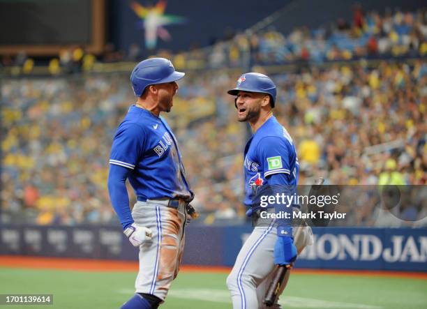 George Springer of the Toronto Blue Jays, center, celebrates hitting a second inning three-run inside the park home run against the Tampa Bay Rays...