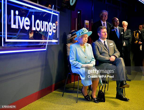 Queen Elizabeth II watches a performance of Irish band The Script in the 'Live Lounge' as she opens the new BBC Broadcasting House on June 7, 2013 in...