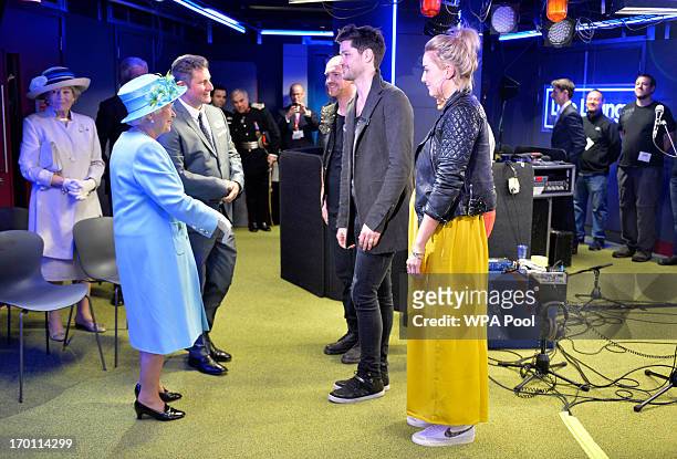Queen Elizabeth II meets Danny O'Donoghue of Irish band The Script in the 'Live Lounge' as she opens the new BBC Broadcasting House on June 7, 2013...