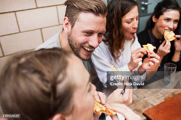 friends enjoying time together at a pizza restaurant - pizzeria stock pictures, royalty-free photos & images