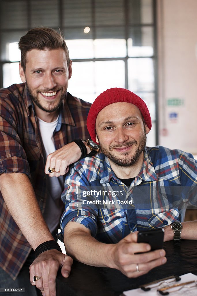 Two cheerful male friends hanging out together at local cafe