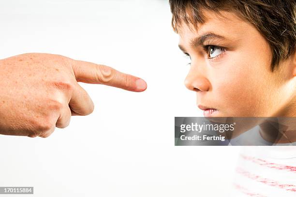 defiant child being disciplined. - rebellion stock pictures, royalty-free photos & images