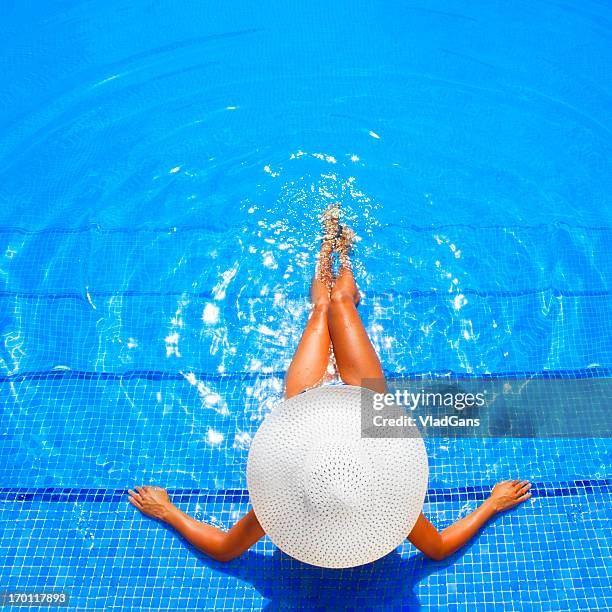 woman relaxing in a resort swimming pool - lido stock pictures, royalty-free photos & images