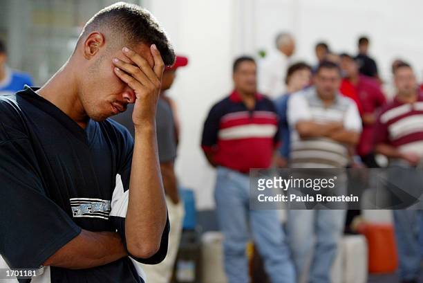 Frustrated Venezuelans wait in line for hours at a gas station on Christmas day December 25, 2002 in downtown Caracas, Venezuela. Business, labor and...