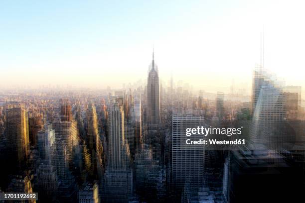 usa, new york state, new york city, defocused view of midtown manhattan at sunset - empire state building stock pictures, royalty-free photos & images