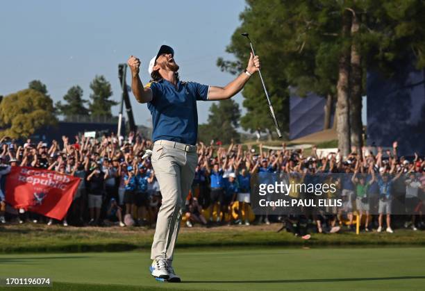 Europe's English golfer, Tommy Fleetwood celebrates his win on the 16th green in his singles match against US golfer, Rickie Fowler to secure the...