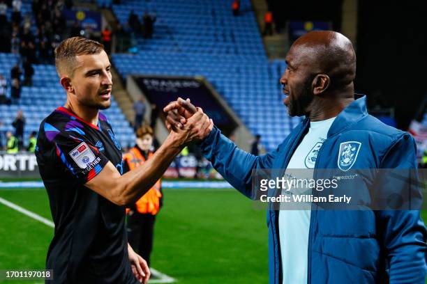 Michal Helik of Huddersfield Town shake hands with manager Darren Moore of Huddersfield Town at full time during the Sky Bet Championship match...