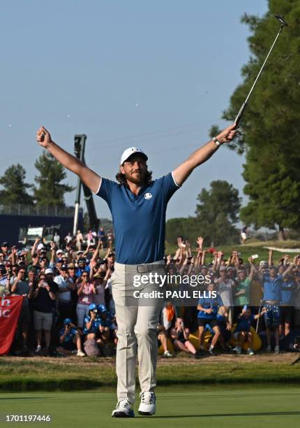 Europe's English golfer, Tommy Fleetwood celebrates the winning putt on the 17th green during his singles match against US golfer, Rickie Fowler on...