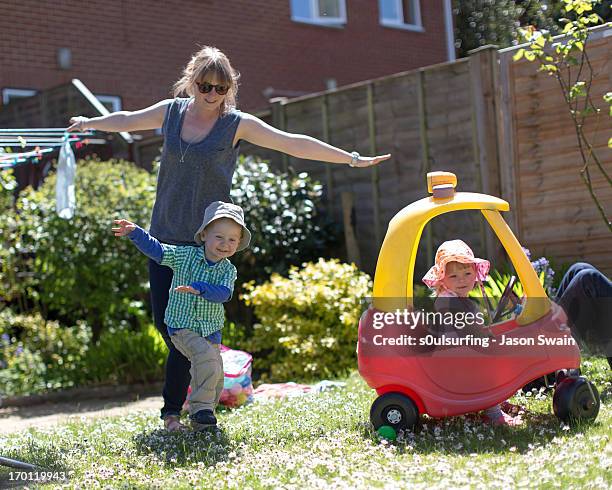 playing aeroplanes in the garden - isle of wight family stock pictures, royalty-free photos & images