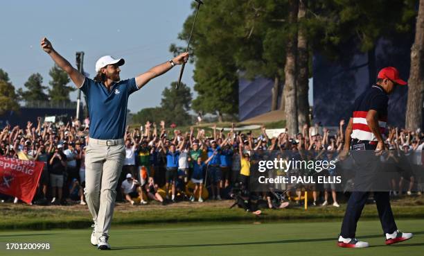 Europe's English golfer, Tommy Fleetwood celebrates his win on the 16th green in his singles match against US golfer, Rickie Fowler to secure the...