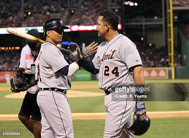 Victor Martinez of the Detroit Tigers congratulates Miguel Cabrera for hitting a home run in the fifth inning against the Texas Rangers at Rangers...