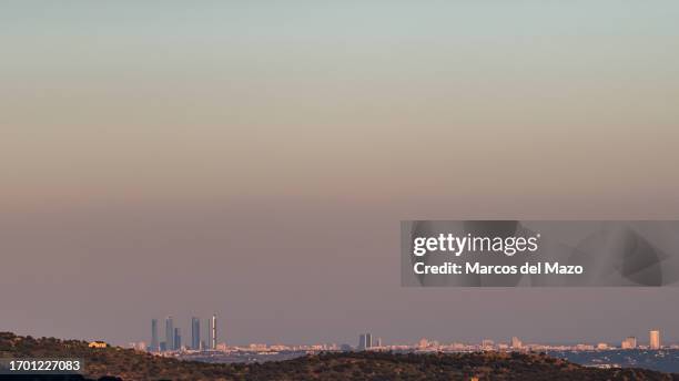 View of the skyline with the skyscrapers of the Four Towers Business Area of Madrid with visible pollution during a day of poor air quality with high...