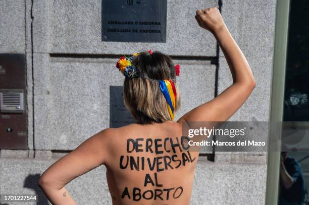 An activist of feminist group FEMEN showing on her back a message reading "universal right to abortion", protesting in front of the Embassy of...