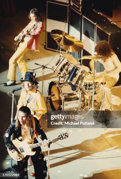 English glam rock group Slade performing on stage, circa 1973. Clockwise, from top, left: Jim Lea, Don Powell, Dave Hill and Noddy Holder.